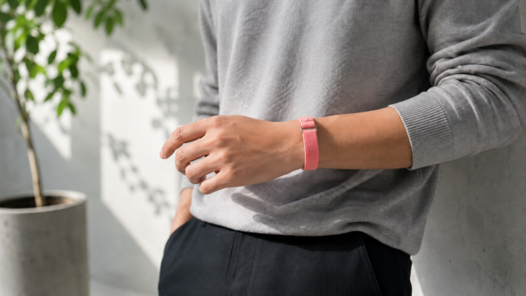 Persona que tiene una pulsera Google Fitbit Air en la muñeca.